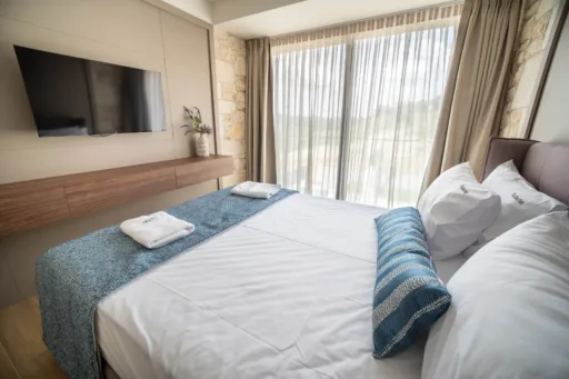 Spacious bedroom with wide windows and soft decor