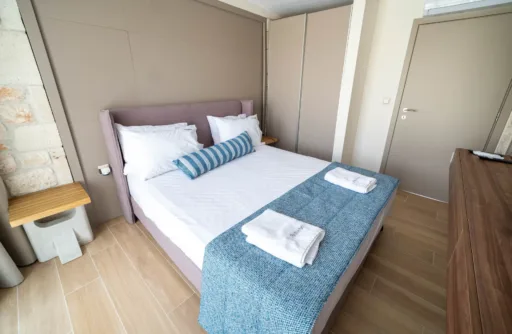 Modern bedroom with bedside table and wardrobe