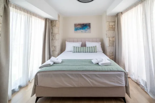 Cozy double bedroom with bright window view