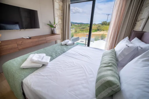 Double bedroom with window overlooking the garden area of villa