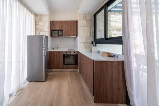 Modern kitchen with wooden cabinets and large windows