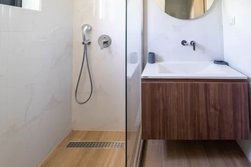 Modern bathroom with walk-in shower and wooden vanity