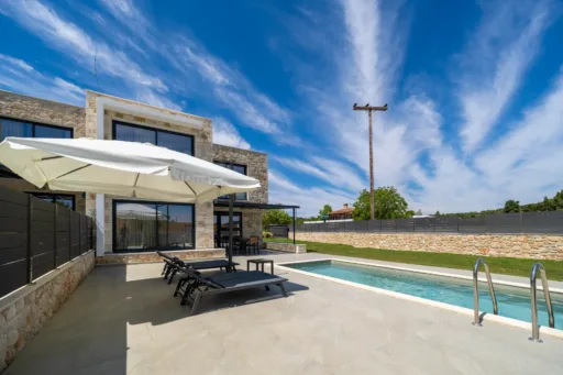 Landscaped garden and private pool with sun loungers at Villa Fos vacation rental