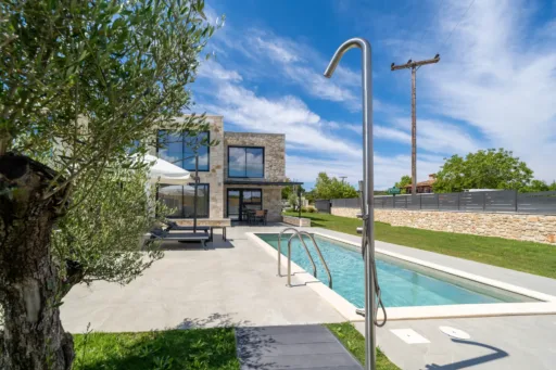 Private pool area with outdoor shower and sunbeds