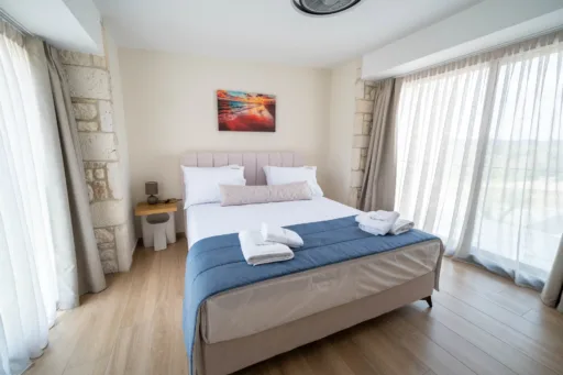 Double bedroom with large windows and curtains