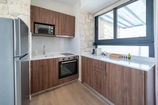 Fully equipped kitchen with modern appliances and natural light