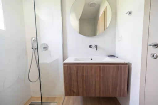Modern bathroom with walk-in shower and glass partition
