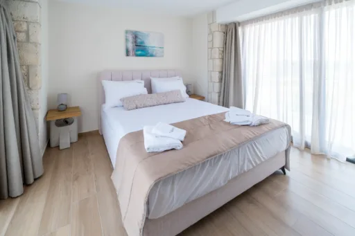 Double bedroom with window overlooking the pool area