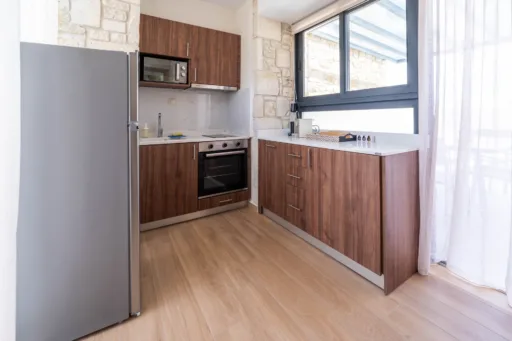 Fully equipped kitchen with wooden cabinets and stainless appliances