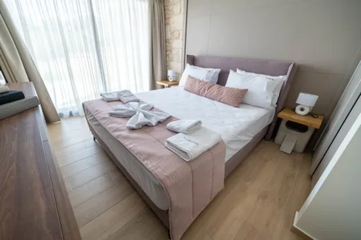 Cozy double bedroom with bedside tables and window view